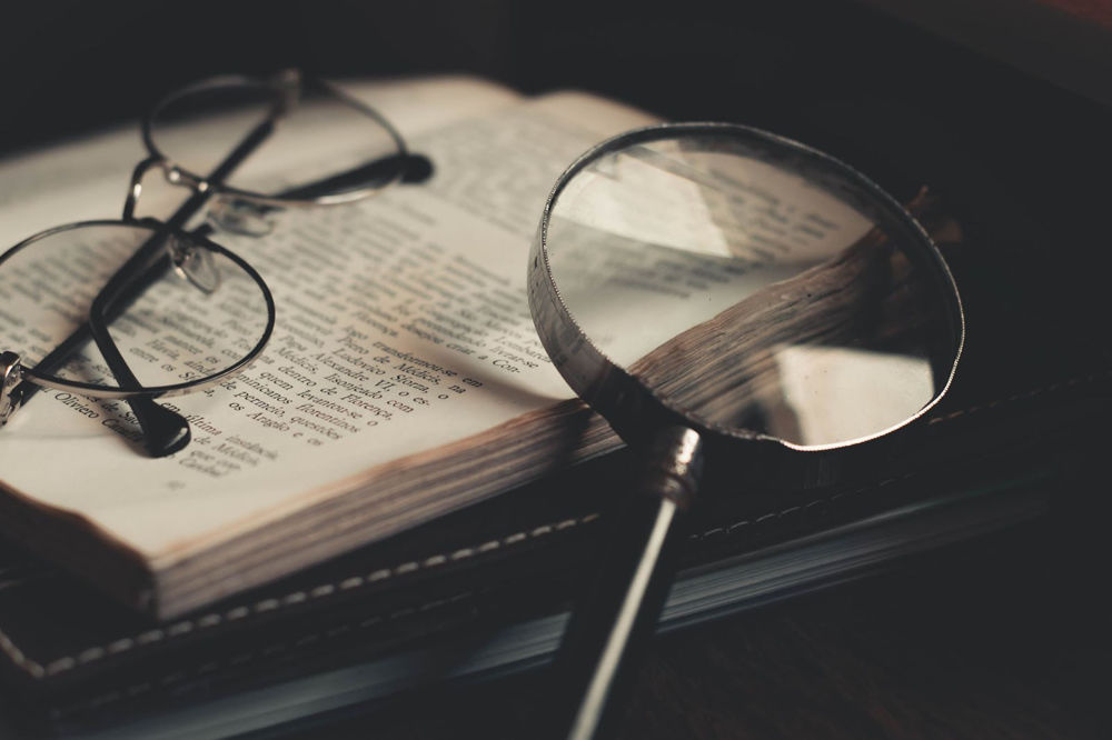 reading glasses, book, and magnifying glass