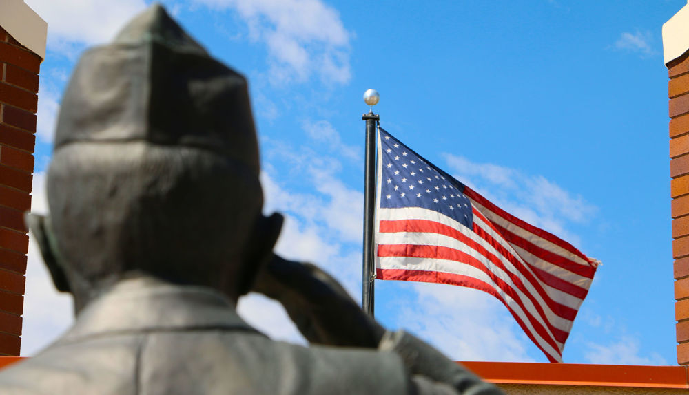 saluting veteran statue american flag
